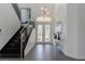 Bright foyer featuring a staircase, elegant tile flooring, a modern light fixture and decorative mirrors at 1910 Lake Roberts Landing Dr, Winter Garden, FL 34787