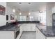 Well-lit kitchen features granite counters, stainless appliances and white cabinets at 1910 Lake Roberts Landing Dr, Winter Garden, FL 34787
