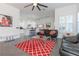Open living room with large windows, ceiling fan, tile floors, and modern furniture at 1910 Lake Roberts Landing Dr, Winter Garden, FL 34787
