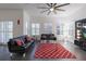 Open living room with large windows, ceiling fan, tile floors, and modern furniture at 1910 Lake Roberts Landing Dr, Winter Garden, FL 34787