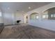 Bright loft area with gray carpet, white walls, and transom windows at 1910 Lake Roberts Landing Dr, Winter Garden, FL 34787