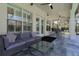 Covered patio with a sofa, coffee table, and outdoor dining set at 1910 Lake Roberts Landing Dr, Winter Garden, FL 34787