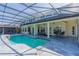 Inviting screened-in pool area with tile decking and spacious outdoor living for relaxation and entertaining at 1910 Lake Roberts Landing Dr, Winter Garden, FL 34787