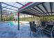 Inviting screened-in pool area featuring a covered patio with comfortable seating and dining space at 1910 Lake Roberts Landing Dr, Winter Garden, FL 34787