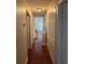Hallway with wood flooring, neutral walls, and practical storage space at 1997 Dixie Belle Dr # 1997C, Orlando, FL 32812