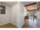 Hallway leading to an open living area featuring hardwood floors and neutral paint at 200 Maitland Ave # 96, Altamonte Springs, FL 32701