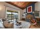 Living room features a brick fireplace and balcony with beautiful outdoor views at 200 Maitland Ave # 96, Altamonte Springs, FL 32701