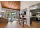 Bright living room with wood ceiling, balcony access and view to the kitchen with bar seating at 200 Maitland Ave # 96, Altamonte Springs, FL 32701