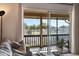 Cozy living room with a lake view through sliding glass doors leading to a charming outdoor balcony at 200 Maitland Ave # 96, Altamonte Springs, FL 32701