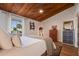 Comfortable bedroom featuring a wood ceiling, well-decorated furniture, and bright natural light at 200 Maitland Ave # 96, Altamonte Springs, FL 32701