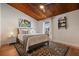 Cozy bedroom with a wood-paneled ceiling, stylish rug, and ample natural light at 200 Maitland Ave # 96, Altamonte Springs, FL 32701