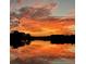 Stunning water view with a fiery sunset reflecting on the lake's surface, silhouetting the shoreline at 200 Maitland Ave # 96, Altamonte Springs, FL 32701