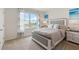 Comfortable bedroom features neutral tones, a large window, and stylish decor for a relaxing retreat at 2129 Pigeon Plum Dr, Haines City, FL 33844