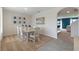 Dining area with carpet and tile flooring, white furnishings and decorative wall art at 2129 Pigeon Plum Dr, Haines City, FL 33844