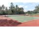 Well-maintained tennis courts, ideal for recreational games, with surrounding trees providing shade and a net at 2165 Westbourne Dr, Oviedo, FL 32765