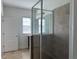 Bright bathroom with a glass enclosed shower, modern sink, and neutral tile flooring at 2205 W Lobelia Dr, Lake Mary, FL 32746