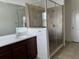 Bathroom with sleek glass shower, dark wood cabinets, and a white countertop sink at 2205 W Lobelia Dr, Lake Mary, FL 32746