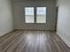 Well-lit bedroom with hardwood flooring and two large windows providing natural light at 2205 W Lobelia Dr, Lake Mary, FL 32746