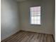 Bedroom boasts neutral walls, wood-look flooring and a window with blinds at 2205 W Lobelia Dr, Lake Mary, FL 32746