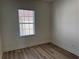 Bedroom boasts neutral walls, wood-look flooring and a window with blinds at 2205 W Lobelia Dr, Lake Mary, FL 32746