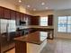 Open kitchen features dark wood cabinets, granite countertops and stainless steel appliances at 2205 W Lobelia Dr, Lake Mary, FL 32746