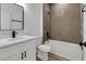 Modern bathroom featuring a vanity with matte black hardware and a tiled shower-tub combination at 2409 Sw 170Th Pl, Ocala, FL 34473
