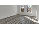 Bright, airy bedroom with two windows providing natural light and gray wood-look flooring at 2409 Sw 170Th Pl, Ocala, FL 34473