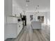 Open-concept kitchen with white countertops, island with seating, and sleek appliances at 2409 Sw 170Th Pl, Ocala, FL 34473