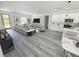 Inviting living room with wood floors, a modern sofa, and an open floorplan at 2409 Sw 170Th Pl, Ocala, FL 34473