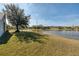 Picturesque backyard view with a serene lake and mature trees, offering a peaceful retreat at 2512 Stoneworth Ct, Orlando, FL 32825