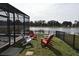 Backyard featuring colorful Adirondack chairs overlooking a tranquil lake at 2659 Magpie Way, Sanford, FL 32773