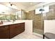 Modern bathroom featuring a frameless shower, brown vanity, and white quartz countertops at 2659 Magpie Way, Sanford, FL 32773