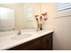 Elegant bathroom vanity with double sinks, quartz countertops, and decorative floral arrangement at 2659 Magpie Way, Sanford, FL 32773