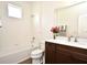 Bright bathroom featuring a shower-tub combo, stylish vanity with sink, and a large mirror, offering a clean, modern space at 2659 Magpie Way, Sanford, FL 32773