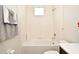 Neat bathroom with shower-tub combo, tiled walls, and a white toilet, offering a clean and functional space at 2659 Magpie Way, Sanford, FL 32773