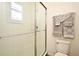 Clean bathroom featuring a glass-enclosed shower with white tile and neutral-toned towels at 2659 Magpie Way, Sanford, FL 32773