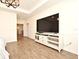 Open floor plan with wood-look tile and a TV console with plenty of storage at 2659 Magpie Way, Sanford, FL 32773