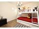 Bright bedroom with a bunk bed, wood-look tile floor and a charming chandelier at 2659 Magpie Way, Sanford, FL 32773