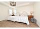 Spacious bedroom with wood-look floors, tray ceilings, plantation shutters and a large bed at 2659 Magpie Way, Sanford, FL 32773