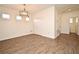 Open dining room with wood-look tile floors and natural light streaming in through the windows at 2659 Magpie Way, Sanford, FL 32773