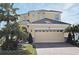 Charming two-story home featuring a two-car garage, brick driveway, and lush tropical landscaping at 2659 Magpie Way, Sanford, FL 32773