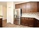 Kitchen showcasing stainless steel refrigerator, elegant cabinets, and beautiful mosaic backsplash at 2659 Magpie Way, Sanford, FL 32773