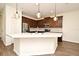 Modern kitchen features stainless steel appliances, a spacious island, and stylish pendant lighting at 2659 Magpie Way, Sanford, FL 32773