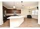 Modern open kitchen featuring stainless steel appliances and a large central island with seating at 2659 Magpie Way, Sanford, FL 32773