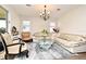 Bright living room featuring a cozy sofa, decorative rug, and elegant chandelier at 2659 Magpie Way, Sanford, FL 32773