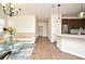 Open-concept living room with wood floors, a view of the kitchen, and a comfortable seating area at 2659 Magpie Way, Sanford, FL 32773