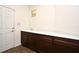Mud room featuring a side door, long counter with sink and dark cabinets, perfect for keeping things organized at 2659 Magpie Way, Sanford, FL 32773