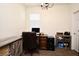 Comfortable home office with wood-look floors, window with shutter, and a large desk perfect for work or study at 2659 Magpie Way, Sanford, FL 32773