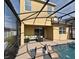 Relaxing outdoor pool area with lounge chairs and seating under a screened enclosure, perfect for entertaining and enjoying the sunshine at 2659 Magpie Way, Sanford, FL 32773