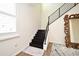 Modern staircase with a dark metal railing, and wooden treads offering style and functionality at 2659 Magpie Way, Sanford, FL 32773